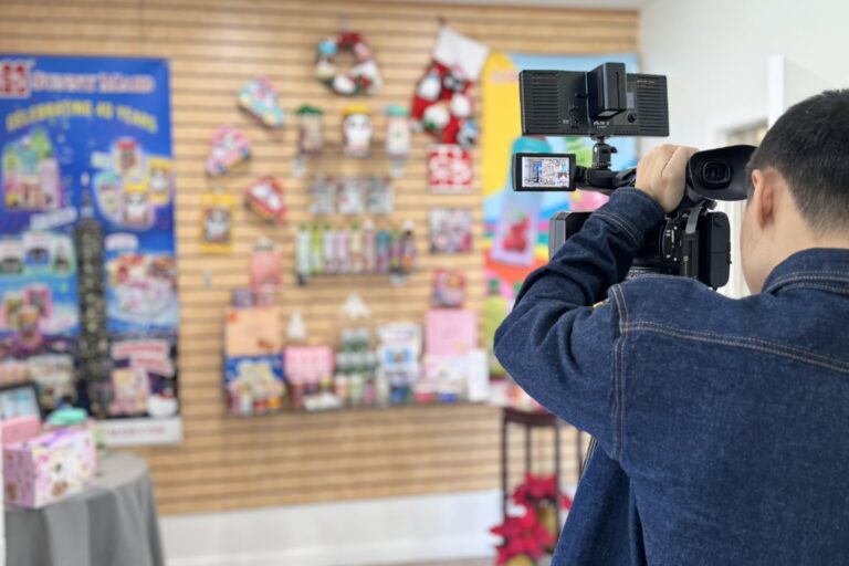 camera shooting video of wall display